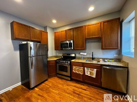 A kitchen with wooden cabinets and stainless steel appliances.