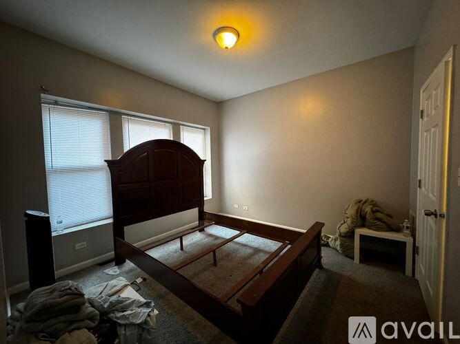 A bedroom with a bed, window, and a carpet.