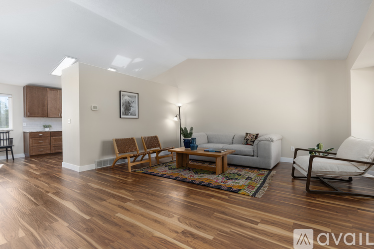 A living room with wooden floors and furniture.