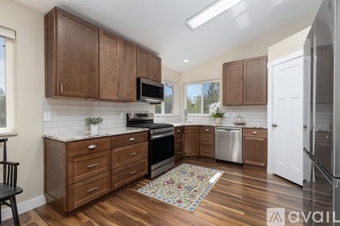 A kitchen with wooden cabinets and a white countertop.