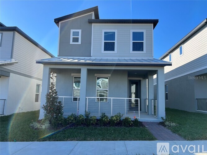 A two-story house with a front porch is for sale.