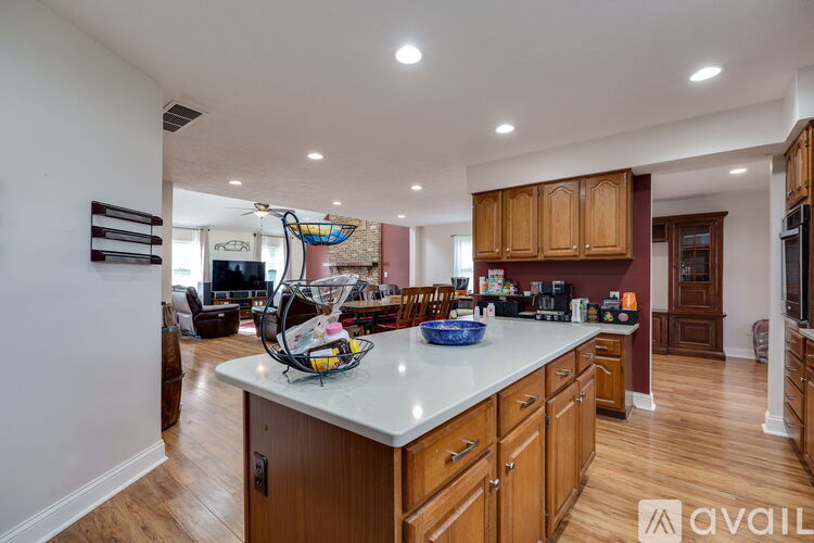 A kitchen with wooden cabinets and a white countertop.