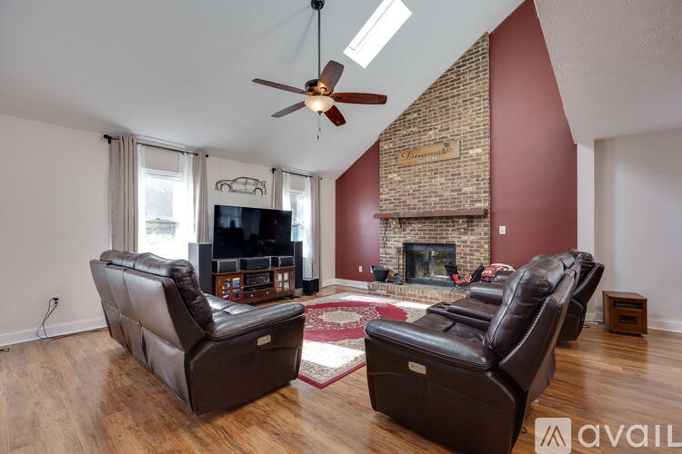 A living room with two brown leather sofas and a fireplace.
