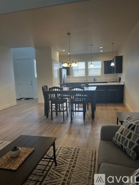 A kitchen with a dining table and chairs.