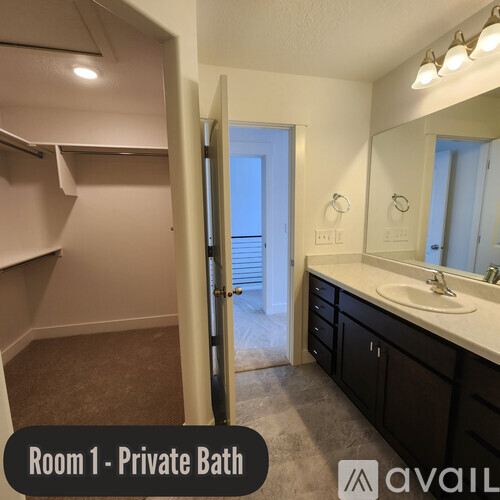 A bathroom with a private bath and a mirror.