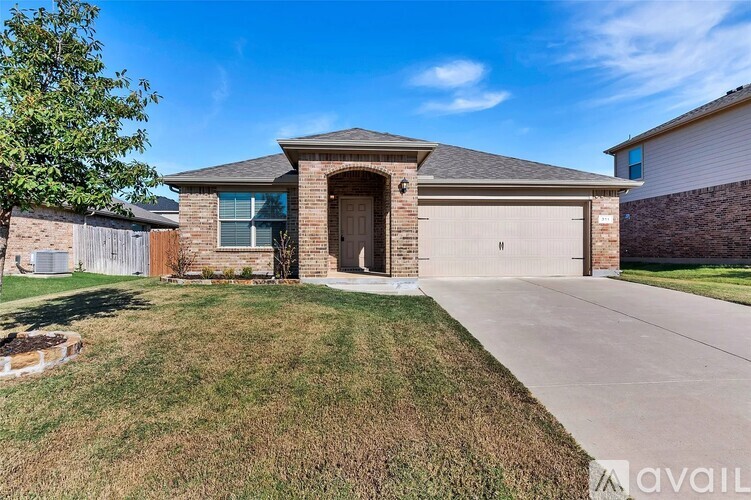 A house with a garage and a driveway in front.