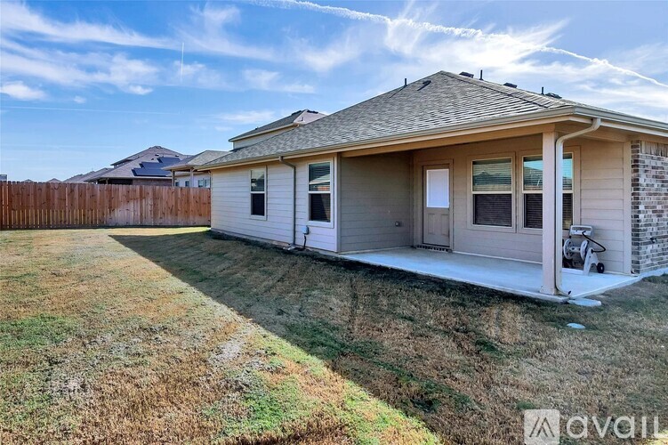 A house with a brown fence and a white door is for sale.
