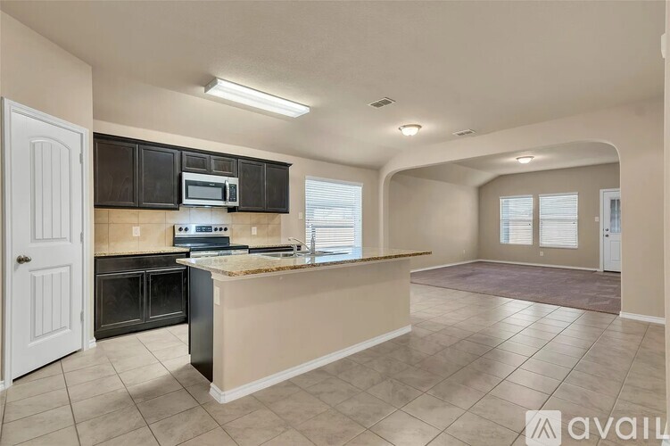 A kitchen with a countertop and a microwave above it.