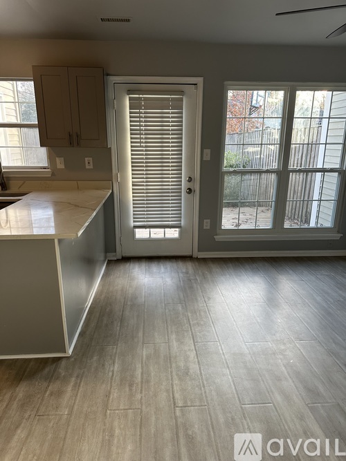 A kitchen with a white counter and a white door.