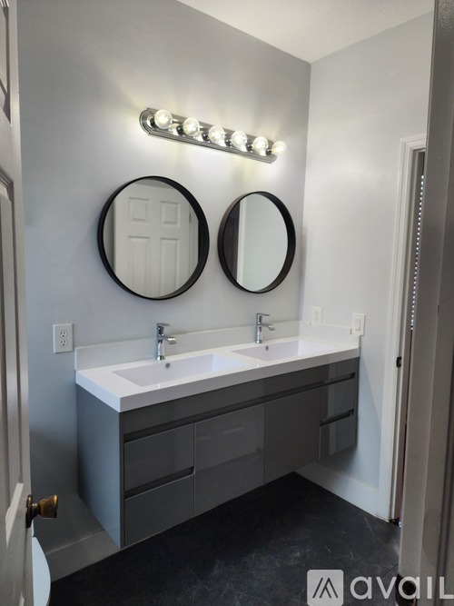 A bathroom with two sinks and two mirrors.