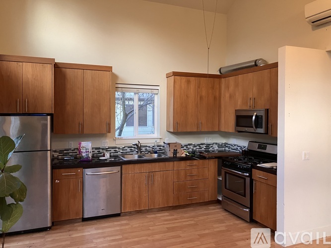A kitchen with wooden cabinets and stainless steel appliances.