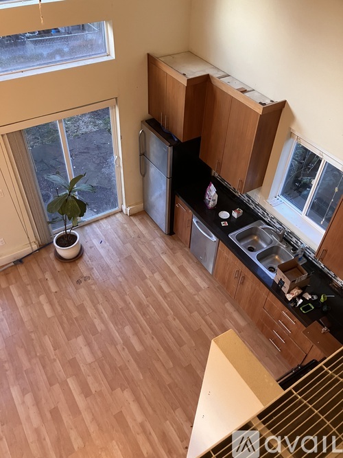 A kitchen with wooden floors and cabinets.