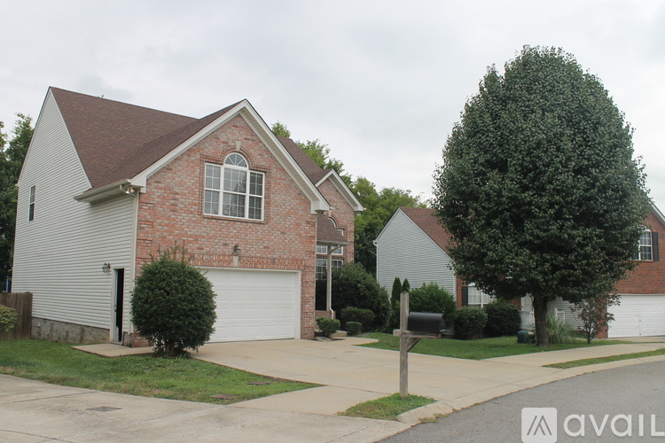 A house with a brick facade and a white garage door is shown.