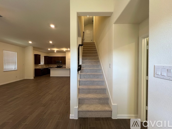 A staircase in a house with a carpeted runner.