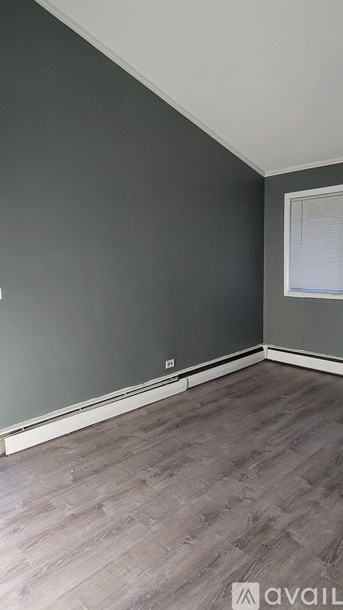 A room with grey walls and wooden flooring.