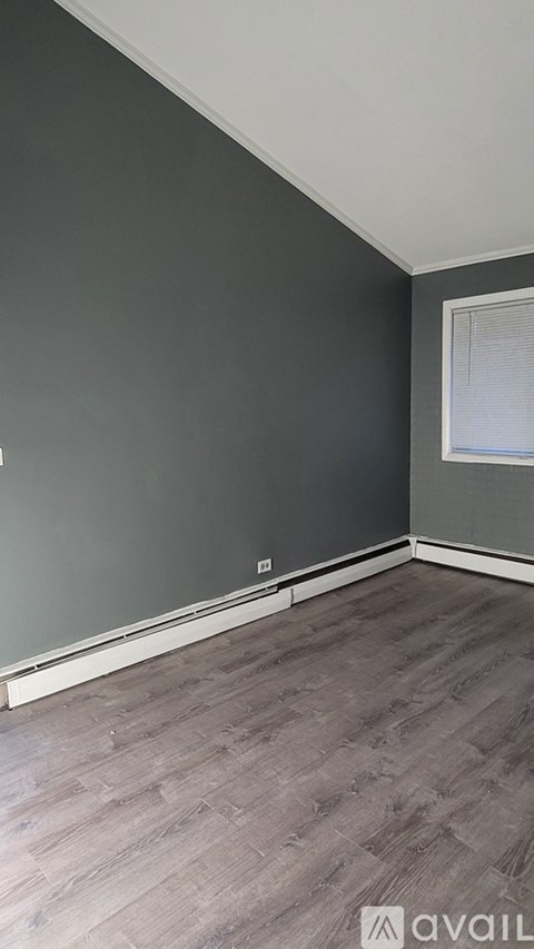 A room with grey walls and wooden flooring.