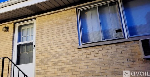 A brick building with a window and a door.