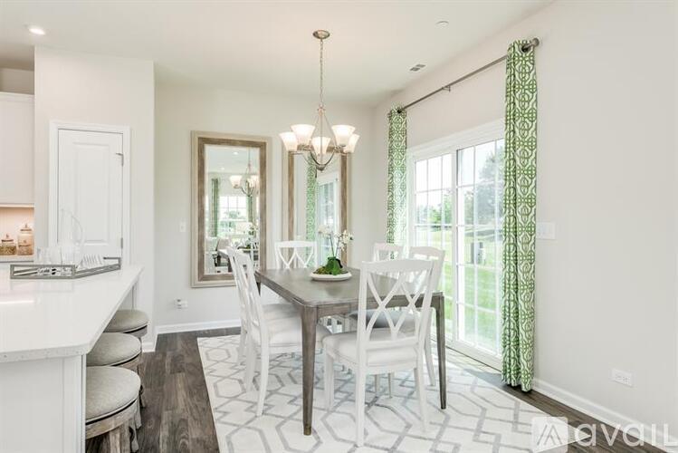 A dining room with a table set for four.