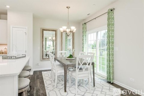 A dining room with a table set for four.