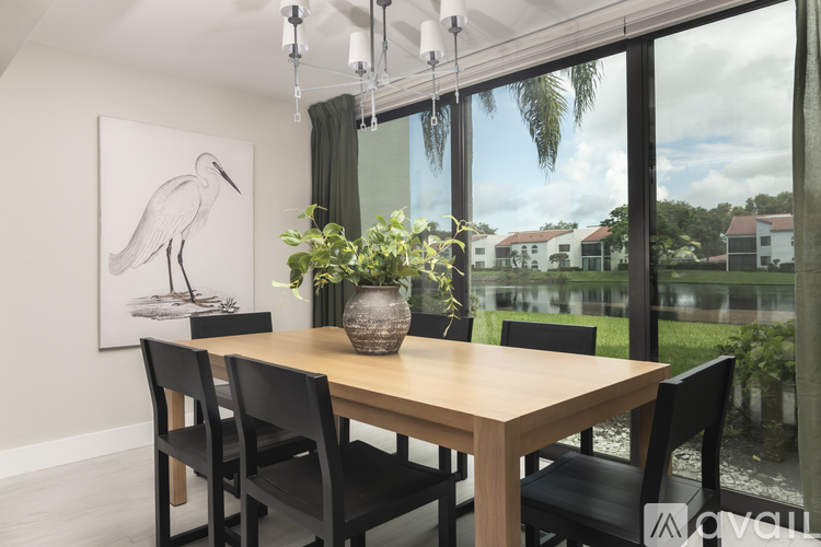 A dining room with a wooden table and chairs.