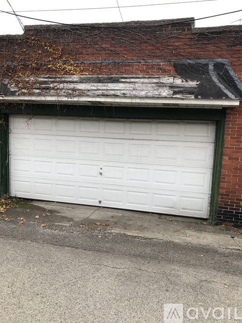 A white garage door is closed and locked.