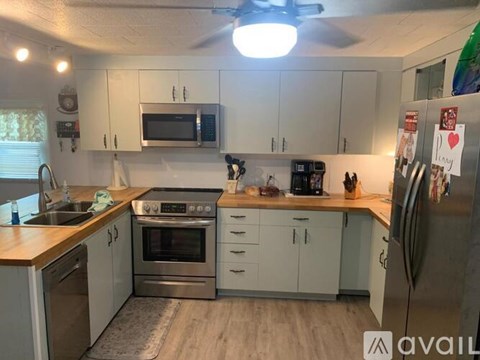A kitchen with white cabinets and stainless steel appliances.