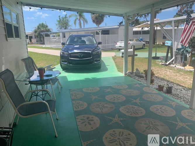 A car is parked in a covered patio area.