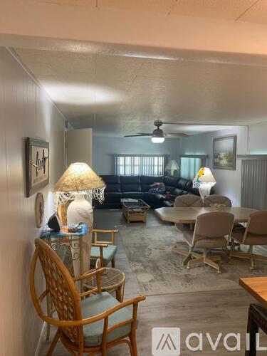 A living room with a sofa, chairs, and a table.