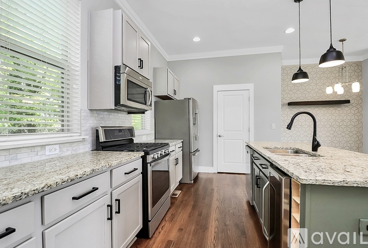A kitchen with granite countertops and stainless steel appliances.