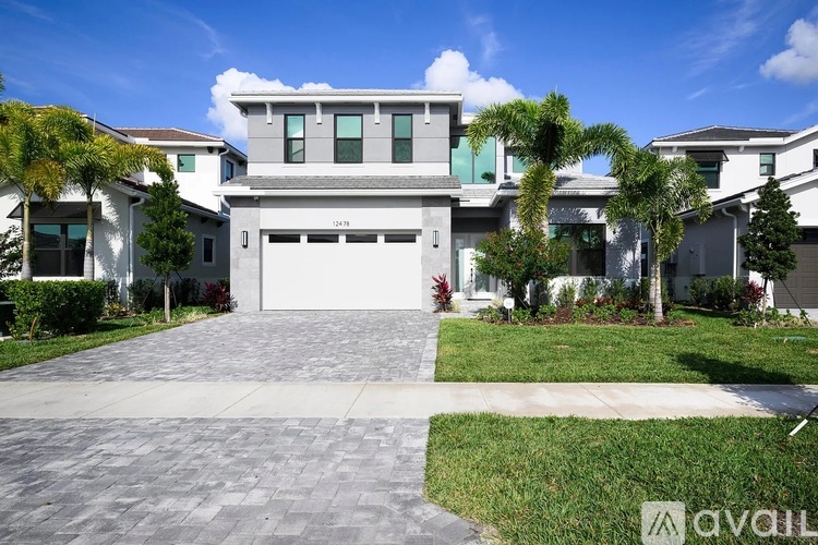 A modern house with a white garage door is for sale.