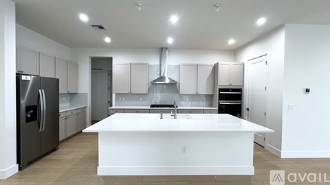 A modern kitchen with a large island in the center.