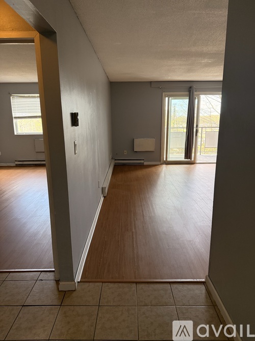 A room with wooden floors and a window.