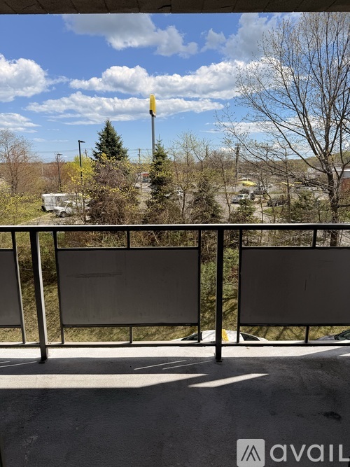 A view from a balcony with a sign that reads "avail" and a yellow flag on a pole.