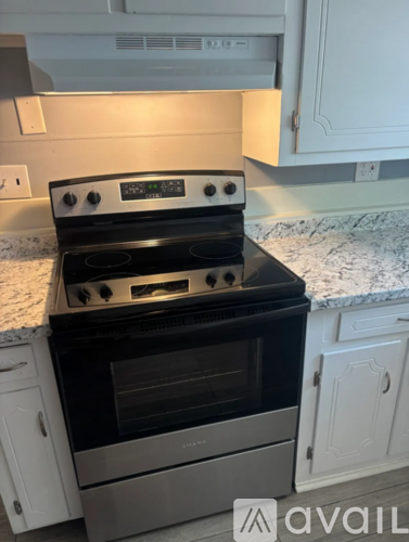 A black oven with a digital display is in a kitchen.