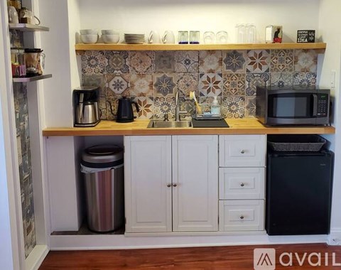 A kitchen with a tiled backsplash and a wooden countertop.