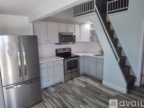 A kitchen with a stainless steel refrigerator and stove.