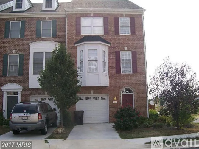 A two story brick house with a white garage door.