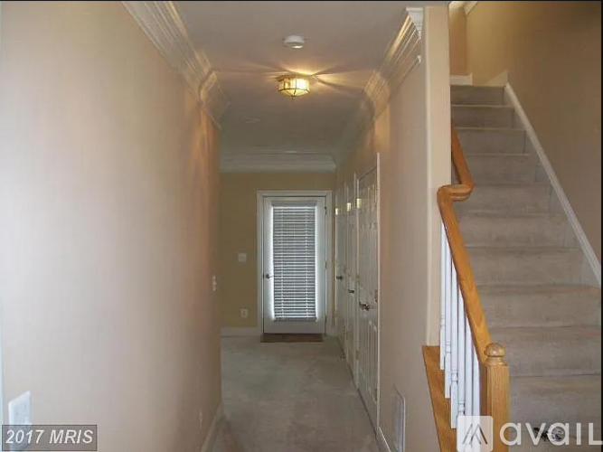 A hallway with a staircase on the right side.