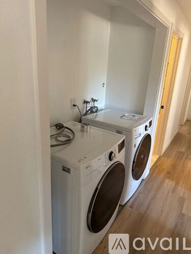 A washing machine and dryer are sitting on a counter in a room.