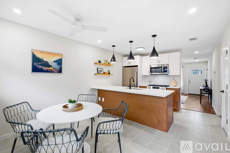 A modern kitchen with a dining table and chairs.