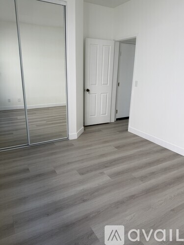 A room with a white door and a glass door.