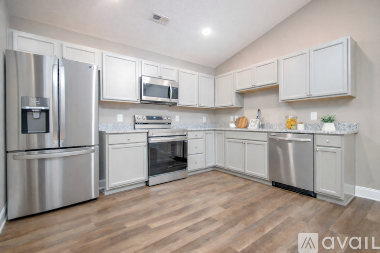 A kitchen with white cabinets and stainless steel appliances.