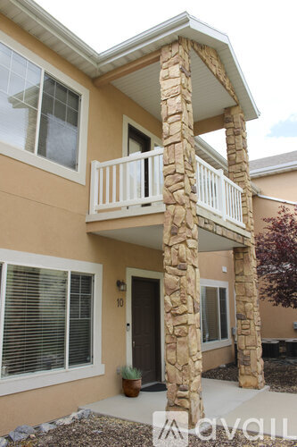 A house with a balcony and a door numbered 10.