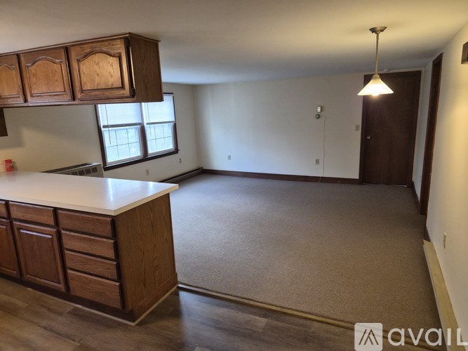 A kitchen with wooden cabinets and a white countertop.