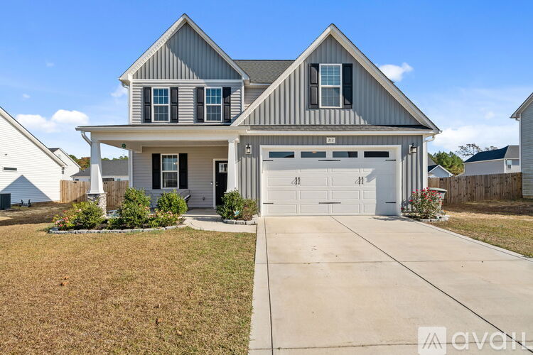 A two-story house with a garage is shown in the image.