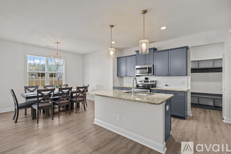 A kitchen with a dining table and chairs is available for rent.