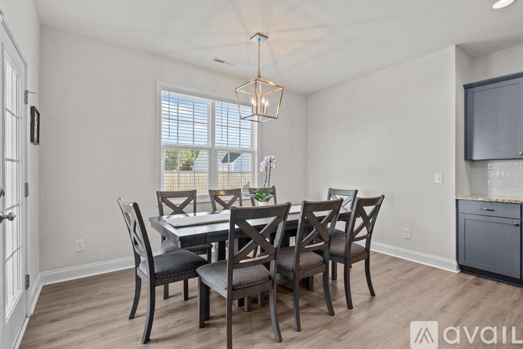 A dining room with a table set for six.