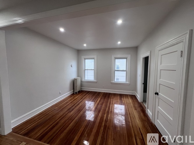 A room with wooden floors and white walls.