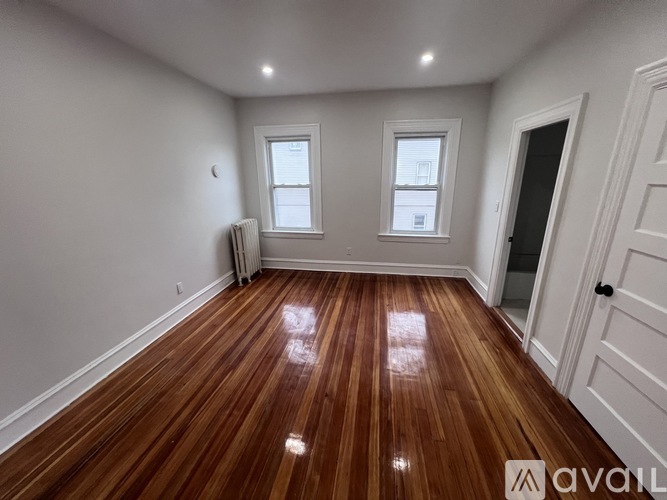 A room with wooden floors and white walls.