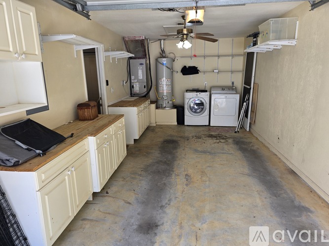 A kitchen with a washer and dryer in the background.
